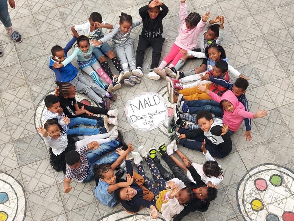 MALD students sitting in a circle celebrating Down Syndrome Day